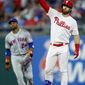 Philadelphia Phillies&#39; Bryce Harper, right, celebrates near New York Mets&#39; Robinson Cano after hitting an RBI-double during the fourth inning of a baseball game, Monday, June 24, 2019, in Philadelphia. (AP Photo/Matt Slocum)
