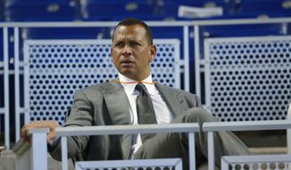 FILE - In this June 23, 2017, file photo, former baseball player Alex Rodriguez sits in the stands before the start of a baseball game in Miami. Rodriguez said he is happy with the improvements he has made in his second year in the booth for ESPN’s “Sunday Night Baseball”, but he is looking to get better during the second half of the season. (AP Photo/Wilfredo Lee, File)