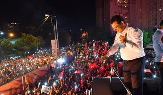 Ekrem Imamoglu, the candidate of the secular opposition Republican People&#39;s Party, CHP, talks to supporters from atop his campaign bus during a celebratory rally in Istanbul, late Sunday, June 23, 2019. The opposition candidate for mayor of Istanbul celebrated a landmark win Sunday in a closely watched repeat election that ended weeks of political tension and broke the long hold President Recep Tayyip Erdogan&#39;s party had leading Turkey&#39;s largest city. (Onur Gunay/Imamoglu Media team via AP)
