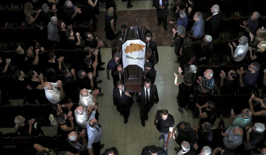 Pallbearers carry the coffin of the former Cyprus' President Dimitris Christofias during his state funeral at the Orthodox Christian Church of the Lord's Wisdom in capital Nicosia, Cyprus, Tuesday, June 25, 2019. European communist and left-wing party heads and leaders from ethnically split Cyprus' breakaway Turkish Cypriot community were among those attending a funeral service for the country's former president Christofias. (AP Photo/Petros Karadjias)