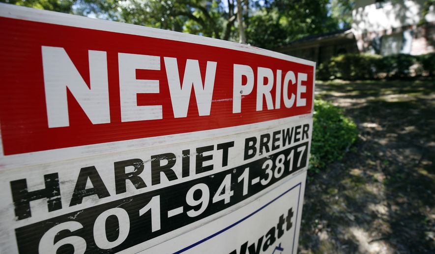 In this June 13, 2019, photo a house on the market has a "new price" sign fixed on the realtor's sign in northeast Jackson, Miss. On Tuesday, June 25, the Standard & Poor's/Case-Shiller 20-city home price index for April is released. (AP Photo/Rogelio V. Solis)