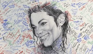 FILE - This July 7, 2009 file photo shows signatures on a poster of the late pop icon Michael Jackson at the Charles H. Wright Museum of African American History in Detroit. Tuesday, June 25, 2019, marks the tenth anniversary of Jackson&#39;s death. (AP Photo/Carlos Osorio, File)