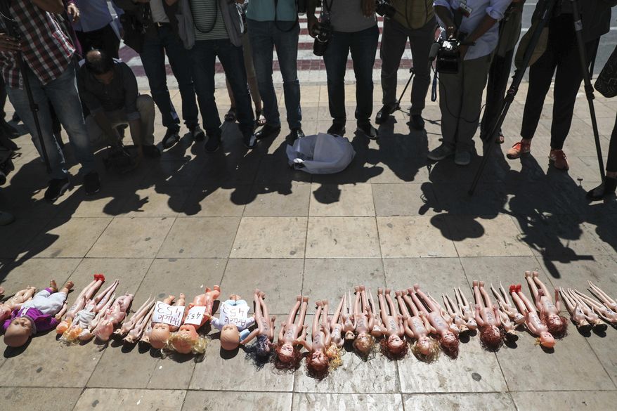 Dolls are laid out in front of Rabat's parliament by pro-choice protesters, to pressure legislatures to pass a law to protect women from unsafe and clandestine abortions, Morocco, Tuesday, June 25, 2019. The dolls symbolically exhibits the fate of undesired Moroccan children, whose mothers do not have the means or the capacities to care for them. (AP Photo/Mosa'ab Elshamy)