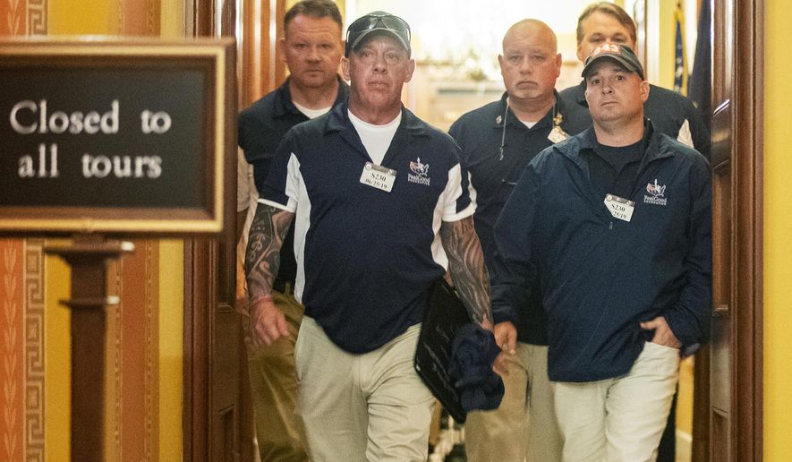 Sept. 11 first responders John Feal, front left, Ret. Lt. Michael O'Connell, front right, and other first responders leave the office of Senate Majority Leader Mitch McConnell, following their meeting at McConnell's office on Capitol Hill in Washington, Tuesday, June 25, 2019. (AP Photo/Manuel Balce Ceneta)