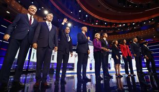 From left, New York City Mayor Bill de Blasio, Rep. Tim Ryan, D-Ohio, former Housing and Urban Development Secretary Julian Castro, Sen. Cory Booker, D-N.J., Sen. Elizabeth Warren, D-Mass., former Texas Rep. Beto O’Rourke, Sen. Amy Klobuchar, D-Minn., Rep. Tulsi Gabbard, D-Hawaii, Washington Gov. Jay Inslee, and former Maryland Rep. John Delaney pose for a photo on stage before the start of a Democratic primary debate hosted by NBC News at the Adrienne Arsht Center for the Performing Arts, Wednesday, June 26, 2019, in Miami. (AP Photo/Brynn Anderson)