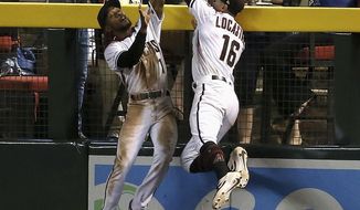 Arizona Diamondbacks center fielder Jarrod Dyson, left, makes a catch taking a home run away from Los Angeles Dodgers&#39; Joc Pederson as Dyson collides with Diamondbacks right fielder Tim Locastro (16) during the seventh inning of a baseball game Wednesday, June 26, 2019, in Phoenix. (AP Photo/Ross D. Franklin)