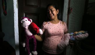 Rosa Ramirez sobs as she shows journalists toys that belonged to her nearly 2-year-old granddaughter Valeria in her home in San Martin, El Salvador, Tuesday, June 25, 2019. The drowned bodies of Ramirez&#39;s son, 25-year-old Oscar Alberto Martinez Ramirez, and his daughter were located Monday morning on the banks of the Rio Grande, a day after the pair were swept away by the current when the young family tried to cross the river to Brownsville, Texas. Her daughter-in-law Tania Vanessa Avalos, 21, survived. (AP Photo/Antonio Valladares)