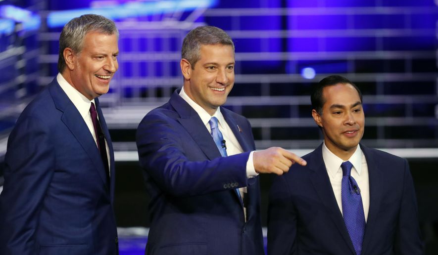 Democratic presidential candidates New York City Mayor Bill de Blasio, Rep. Tim Ryan, D-Ohio, and former Housing and Urban Development Secretary Julian Castro stand on the stage before a Democratic primary debate hosted by NBC News at the Adrienne Arsht Center for the Performing Art, Wednesday, June 26, 2019, in Miami. (AP Photo/Wilfredo Lee)