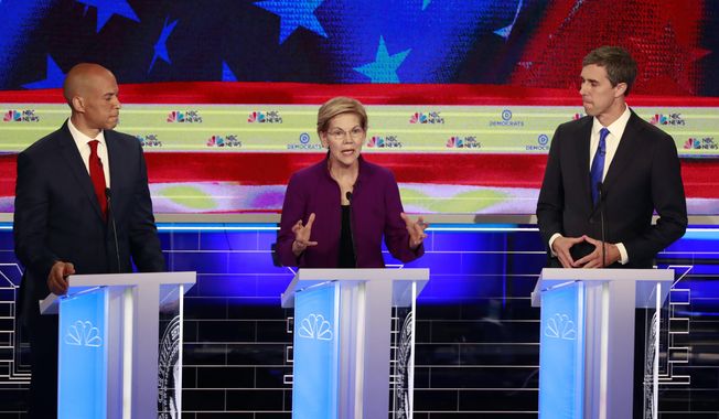 Democratic presidential candidate Sen. Elizabeth Warren, D-Mass., speaks during a Democratic primary debate hosted by NBC News at the Adrienne Arsht Center for the Performing Arts, Wednesday, June 26, 2019, in Miami, as Sen. Cory Booker , D-N.J., and former Texas Rep. Beto O&#x27;Rourke, listen. (AP Photo/Wilfredo Lee)