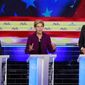 Democratic presidential candidate Sen. Elizabeth Warren, D-Mass., speaks during a Democratic primary debate hosted by NBC News at the Adrienne Arsht Center for the Performing Arts, Wednesday, June 26, 2019, in Miami, as Sen. Cory Booker , D-N.J., and former Texas Rep. Beto O&#39;Rourke, listen. (AP Photo/Wilfredo Lee)
