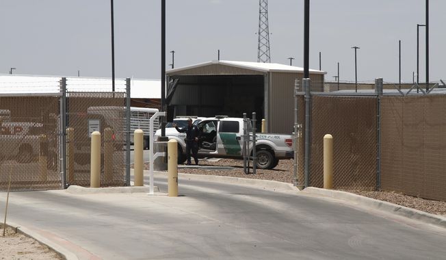 A Customs and Border Patrol officer guards the entrance to the Border Patrol station in Clint, Texas, Wednesday, June 26, 2019. The facility has been a hub for detained children in border patrol custody in New Mexico and West Texas since 2014. (AP Photo/Cedar Attanasio)