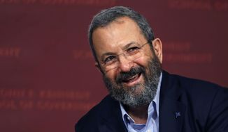 FILE - In this Sept. 21, 2016 file photo, former Israeli Prime Minister Ehud Barak smiles during a lecture at the John F. Kennedy School of Government at Harvard University in Cambridge, Mass.  Barak announced Wednesday, June 26, 2019 that he is returning to politics and is forming a new party that will aim to unseat Prime Minister Benjamin Netanyahu in upcoming elections.  Speaking at a Tel Aviv press conference, Barak called for an end to “Netanyahu’s rule with the radicals, racists and corrupt, with the Messianists and his corrupt leadership.”   (AP Photo/Charles Krupa)