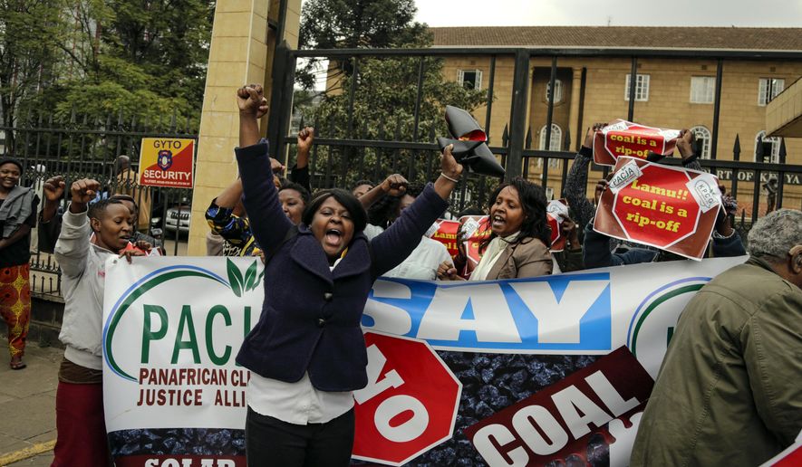 Environmental activists celebrate their victory outside the supreme court building after a tribunal ruling on the construction of a coal-fired power plant, in Nairobi, Kenya Wednesday, June 26, 2019. The Kenyan tribunal blocked the construction of the government-backed plant in Lamu County, which hosts a UNESCO world heritage site and which activists said would cause environmental damage. (AP Photo/Khalil Senosi)