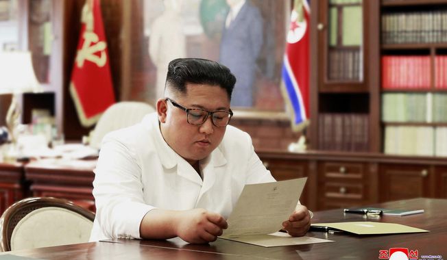 In this undated file photo provided on Sunday, June 23, 2019, by the North Korean government, North Korean leader Kim Jong-un reads a letter from U.S. President Donald Trump. South Korea&#x27;s President Moon Jae-in on Tuesday, June 25, 2019, said North Korean and U.S. officials are holding &amp;quot;behind-the-scenes talks&amp;quot; to set up a third summit between the countries&#x27; leaders. Korean language watermark on image as provided by source reads: &amp;quot;KCNA&amp;quot; which is the abbreviation for Korean Central News Agency. (Korean Central News Agency/Korea News Service via AP, File)