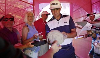 Gary Woodland signs autographs after competing in the Pro-Am for the Rocket Mortgage Classic golf tournament, Wednesday, June 26, 2019, in Detroit. (Mike Mulholland/Ann Arbor News via AP)