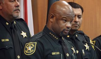 Broward Sheriff Gregory Tony, center, announces that two additional deputies have been fired as a result of the agency&#39;s internal affairs investigation into the mass shooting at Marjory Stoneman Douglas High School in Parkland, at the Broward Sheriff&#39;s Office headquarters in Fort Lauderdale, Fla., Wednesday, June 26, 2019. Tony said deputies Edward Eason and Josh Stambaugh were fired Tuesday for their inaction following the Feb. 14, 2018 shooting.  (Joe Cavaretta/South Florida Sun-Sentinel via AP)