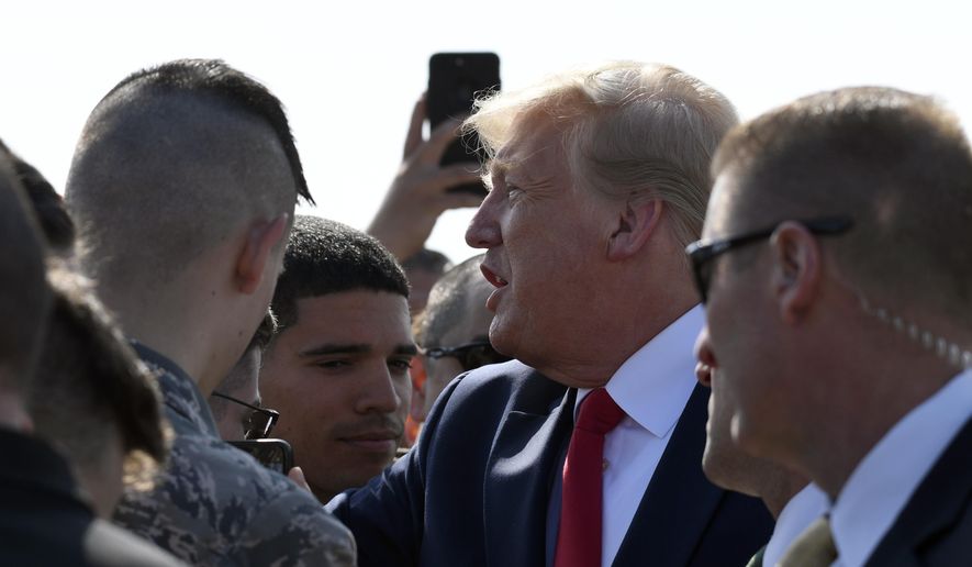 President Donald Trump greets troops at Elmendorf Air Force Base in Anchorage, Alaska, Wednesday, June 26, 2019, during a refueling stop. Trump is heading to the G-20 in Japan, his third overseas trip in a month facing a flurry of international crises, tense negotiations and a growing global to-do list. (AP Photo/Susan Walsh)