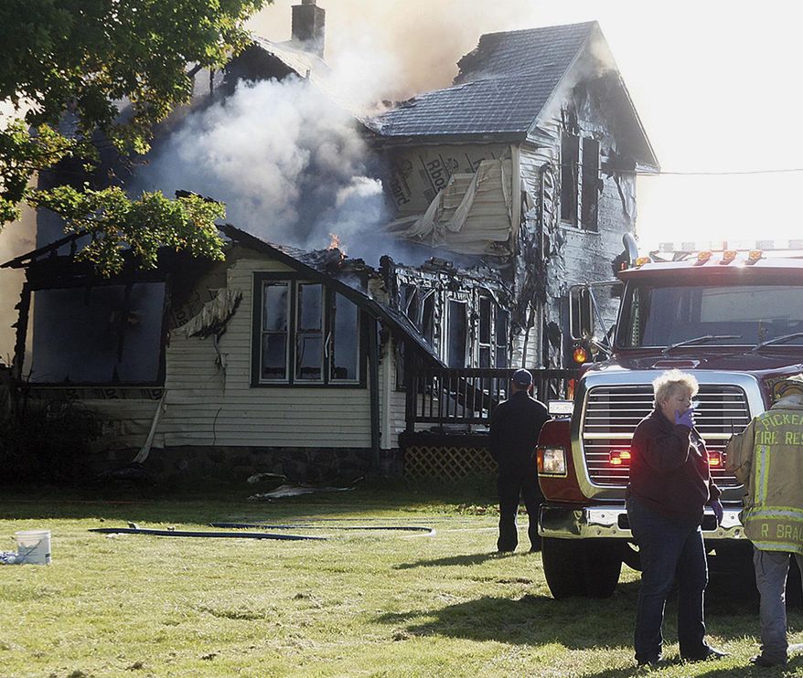 Responders work the scene of a deadly house fire in Pickerel, Wis., Tuesday, June 25, 2019. Authorities say several people, including four children, have died in the house fire in the small Wisconsin town. (Antigo Daily Journal via AP)