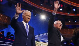 Democratic presidential candidates former vice president Joe Biden, left, and Sen. Bernie Sanders, I-Vt., wave before the start of a Democratic primary debate hosted by NBC News at the Adrienne Arsht Center for the Performing Arts, Thursday, June 27, 2019, in Miami. (AP Photo/Brynn Anderson)