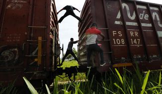 Migrants catch a ride on a freight train on their way north, in Salto del Agua, Chiapas state, Mexico, Tuesday, June 25, 2019. The group’s next stop will be Coatzacoalcos, Veracruz state. Mexico has deployed 6,500 National Guard members in the southern part of the country, plus another 15,000 soldiers along its northern border in a bid to reduce the number of migrants traveling through its territory to reach the U.S. (AP Photo/Marco Ugarte)