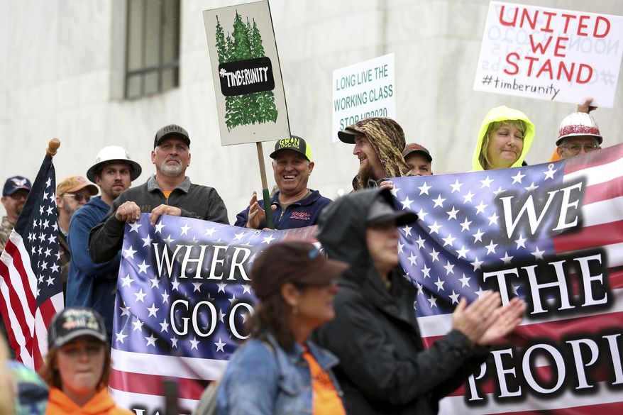 Protesters converge outside the Oregon state Capitol in Salem, Ore. on Thursday, June 27, 2019. Truckers, loggers and farmers say they support the 11 Republican senators who walked out over a week ago to avoid a vote on climate legislation. (Michaela Roman/Statesman-Journal via AP) ** FILE **