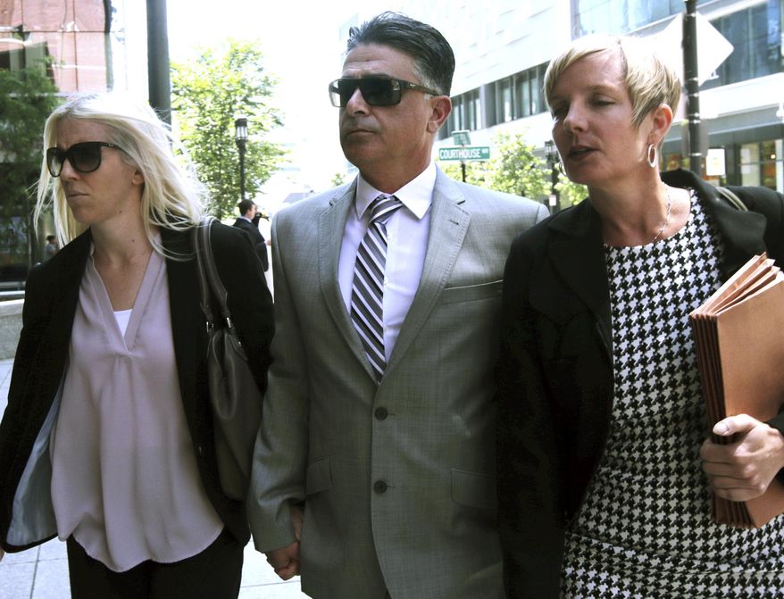 Former USC women's soccer coach Ali Khosroshahin, center, arrives at federal court Thursday, June 27, 2019, in Boston, where he is scheduled to plead guilty to charges in a nationwide college admissions bribery scandal. (AP Photo/Charles Krupa)