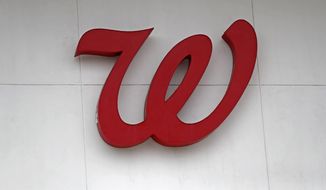 In this Tuesday, June 25, 2019, photo a Walgreens &amp;quot;W&amp;quot; hangs over the entrance of the pharmacy in Jackson, Miss. Walgreens reports financial results on Thursday, June 27. (AP Photo/Rogelio V. Solis)