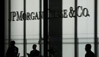 This Oct. 21, 2013, file photo shows the JPMorgan Chase &amp;amp; Co. logo displayed at their headquarters in New York. (AP Photo/Seth Wenig, File)
