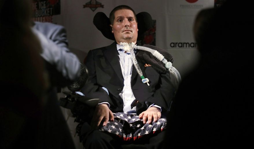 FILE -In this Sept. 18, 2017 photograph, Pete Frates, who is stricken with amyotrophic lateral sclerosis, or ALS, listens to a guest at Fenway Park in Boston. On Thursday, June 27, 2019, Boston College unveiled plans for the Pete Frates Center, a new indoor baseball and softball training facility that will be named after the alumnus who helped popularize the ice bucket challenge. (AP Photo/Charles Krupa, File)