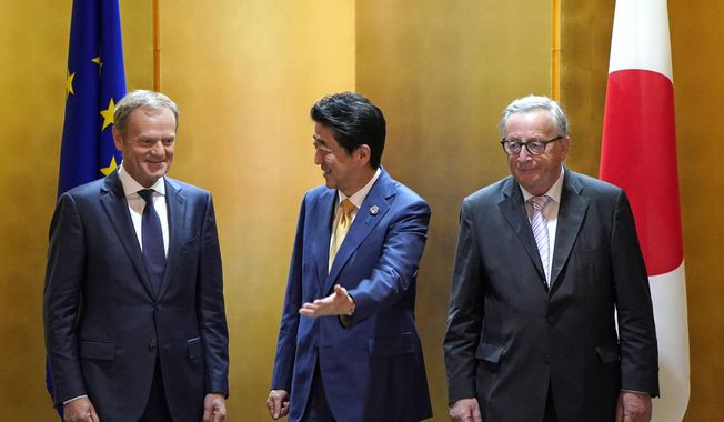 European Commission President Jean-Claude Juncker, right, and European Council President Donald Tusk, left, are escorted by Japanese Prime Minister Shinzo Abe prior to their working lunch on the sidelines of the G20 Summit at the International Exhibition Center in Osaka, Japan, Thursday, June 27, 2019. (Franck Robichon/Pool Photo via AP)