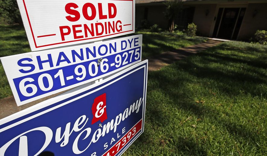 In this June 13, 2019, photo a house on the market has a "sold pending" sign fixed on the realtor's sign in northeast Jackson, Miss. On Thursday, June 27, the National Association of Realtors releases its May report on pending home sales, which are seen as a barometer of future purchases. (AP Photo/Rogelio V. Solis)
