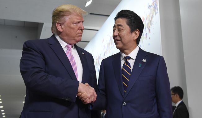 President Donald Trump shakes with Japanese Prime Minister Shinzo Abe during a meeting on the sidelines of the G-20 summit in Osaka, Japan, Friday, June 28, 2019. (AP Photo/Susan Walsh)