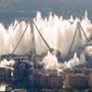 A cloud of dust rises as the remaining spans of the Morandi bridge are demolished in a planned expolosion, in Genoa, Italy, Friday, June 28, 2019. The spectacular planned explosion knocked down the remaining spans and supporting columns of the Italian bridge that collapsed last year, killing 43 people and some 3,500 people who live nearby had been evacuated as a precaution in the last hours; sirens sounded a final warning. (AP Photo/Antonio Calanni)