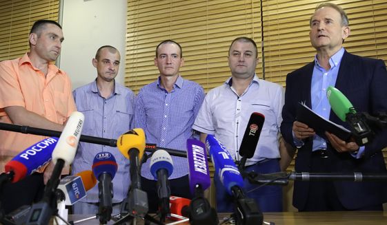 From left, Ukraine&#39;s Yakov Veremeychik, Maxim Goryainov, Dmitry Veliki, Eduard Mikheev, who were held in separatist captivity, talk to media at the National airport &amp;quot;Minsk&amp;quot;, Belarus, Friday, June 28, 2019. Four Ukrainian nationals have been released and handed over to the Ukrainian government. Ukrainian politician Viktor Medvedvchuk is at right. (AP Photo/Sergei Grits)