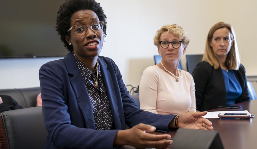 From left, Rep. Lauren Underwood, D-Ill., Rep. Chrissy Houlahan, D-Pa., and Rep. Mikie Sherrill, D-N.J., part of a small group of freshman representatives calling themselves Task Force Sentry, gather for an interview with The Associated Press to discuss their focus on election security, on Capitol Hill in Washington, Thursday, June 27, 2019. (AP Photo/J. Scott Applewhite)