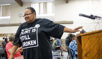 Marijoyce Campbell, a 65-year-old lifelong Flint resident, walks away from the podium in tears after speaking her mind during a community meeting with Flint water prosecutors at UAW Local 659, Friday, June 28, 2019, in Flint, Mich. Campbell said she had a “heavy heart” after learning of the new documents and that some materials the previous investigative team had were heavily redacted. Michigan Solicitor General Fadwa Hammoud and Wayne County Prosecutor Kym Worthy spoke to about 100 residents at the union hall, two weeks after dismissing charges. (Jake May/MLive.com/The Flint Journal via AP)