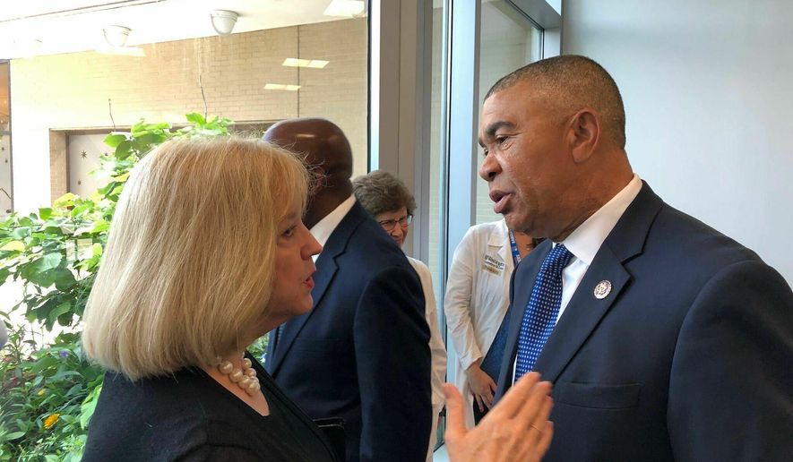 U.S. Rep. William Lacy Clay speaks with St. Louis Mayor Lyda Krewson after a news conference on Friday, June 28, 2019, at St. Louis Children&#39;s Hospital in St. Louis. Clay, a Democrat, discussed a bill he co-sponsored with U.S. Rep. Robin Kelly, D-Illinois, that would allow cities to enact stronger gun laws than their states. Clay said that 43 states currently prohibit cities from enacting stricter gun laws. (AP Photo by Jim Salter)