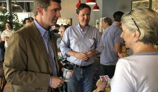 Democratic gubernatorial nominee Andy Beshear, left, speaks with a coffee shop customer on Wednesday, June 29, 2019, in Louisville, Ky., while his former campaign rival, Adam Edelen, center, looks on. Beshear and Edelen appeared together as Democrats put on a united front in their effort to unseat Republican Gov. Matt Bevin in the November election in Kentucky. (AP Photo/Bruce Schreiner)