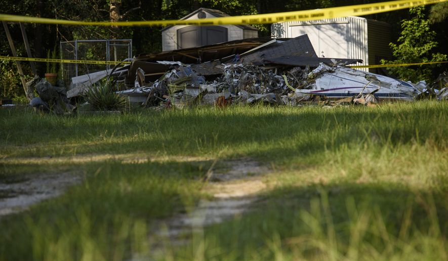 Police tape is set up outside a home where a small plane had crashed into the home late Thursday evening in Hope Mills, N.C. on Friday, June 28, 2019. A single-engine plane crashed into the home, killing the pilot and someone inside the house, authorities said. Another person in the house was seriously hurt. (Melissa Sue Gerrits /The Fayetteville Observer via AP)