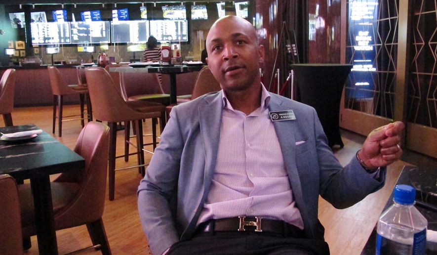 Borgata president Marcus Glover speaks in the Atlantic City, N.J. casino's new sports betting lounge, Friday, june 28, 2019, which opens to public on Saturday. The Borgata and Bally's casinos are opening expanded sportsbooks worth more than $20 million. (AP Photo/Wayne Parry)