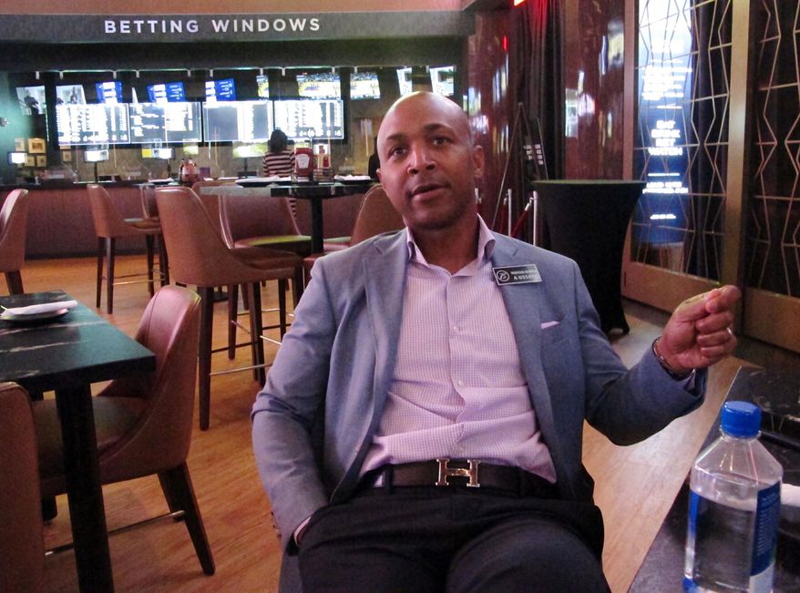 Borgata president Marcus Glover speaks in the Atlantic City, N.J. casino's new sports betting lounge, Friday, june 28, 2019, which opens to public on Saturday. The Borgata and Bally's casinos are opening expanded sportsbooks worth more than $20 million. (AP Photo/Wayne Parry)