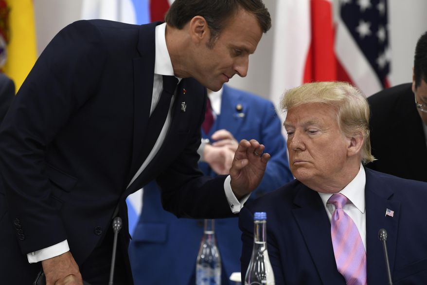 French President Emmanuel Macron speaks with President Donald Trump before a working session at the G-20 summit in Osaka, Japan, Friday, June 28, 2019. (AP Photo/Susan Walsh) **FILE**