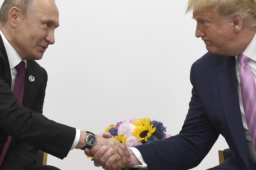 President Donald Trump, right, shakes hands with Russian President Vladimir Putin during a bilateral meeting on the sidelines of the G-20 summit in Osaka, Japan, Friday, June 28, 2019. (AP Photo/Susan Walsh)