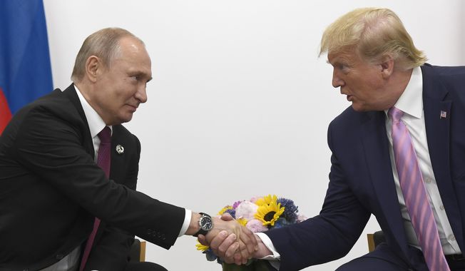 President Donald Trump, right, shakes hands with Russian President Vladimir Putin  during a bilateral meeting on the sidelines of the G-20 summit in Osaka, Japan, Friday, June 28, 2019. (AP Photo/Susan Walsh) **FILE**