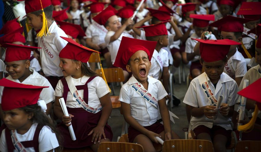 A child yawns during his kindergarten graduation ceremony in Havana, Cuba, Friday, June 21, 2019. (AP Photo/Ramon Espinosa)