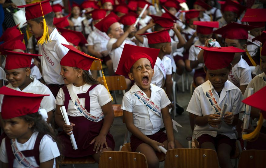 A child yawns during his kindergarten graduation ceremony in Havana, Cuba, Friday, June 21, 2019. (AP Photo/Ramon Espinosa)