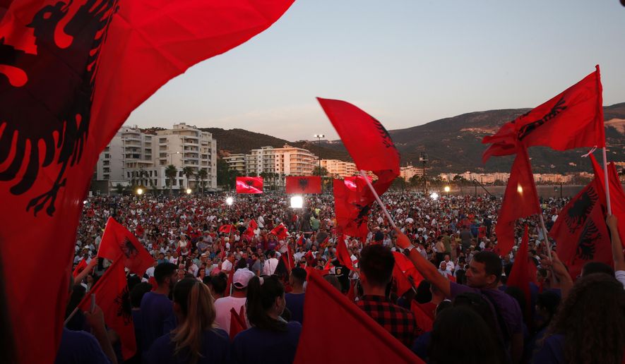 Supporters of prime minister Edi Rama wave Albanian flags during the last election rally in Vlora, southern Albania, Friday, June 28, 2019. Albania's municipal elections don't normally provoke much interest beyond the country's border, but the holding of this weekend's vote — or failure to do so — appears decisive for the tiny Western Balkan country in its bid to start full membership negotiations with the European Union. (AP Photo/Visar Kryeziu)