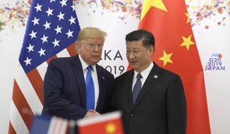 President Donald Trump poses for a photo with Chinese President Xi Jinping during a meeting on the sidelines of the G-20 summit in Osaka, Japan, Saturday, June 29, 2019. (AP Photo/Susan Walsh)