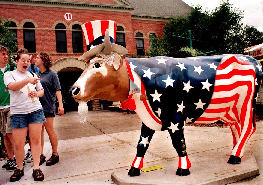 FILE - In this Aug. 13, 1999 file photo, fairgoers enjoy "Uncle Sam," one of several Cows on Parade being exhibited during the 147th Illinois State Fair in Springfield. A herd of fiberglass cows will be returning to Chicago’s Michigan Avenue to mark the 20-year-anniversary of a display of brightly painted bovines captured the attention of the country and inspired other cities to line their streets with their own statues of everything from lobsters to pigs to salmon. For the entire month of July, some 20 of these cows on display it is calling “Cows Come Home” to commemorate “Cows On Parade,” a 1999 public art exhibit consisting of well over 300 of the fiberglass critters sporting everything from baseball hats to Hawaii shorts to ladybug wings (AP Photo/Seth Perlman)