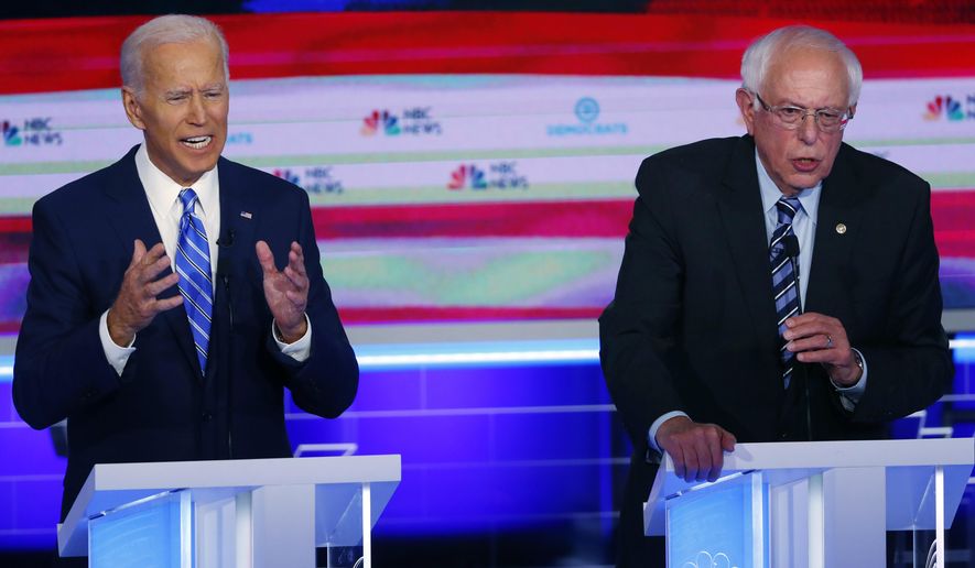 In this June 27, 2019, photo, Democratic presidential candidates former vice president Joe Biden and Sen. Bernie Sanders, I-Vt., speak at the same time during the Democratic primary debate hosted by NBC News at the Adrienne Arsht Center for the Performing Arts in Miami. (AP Photo/Wilfredo Lee)